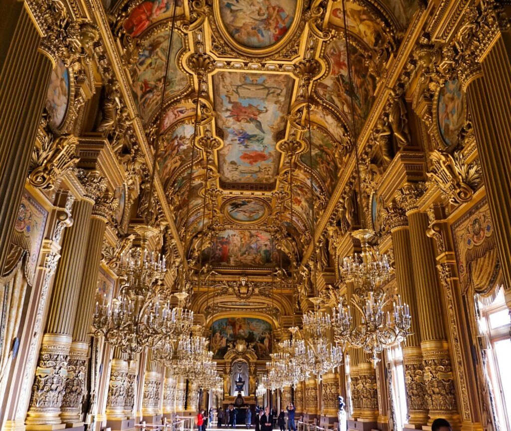 gold hallway with chandeliers