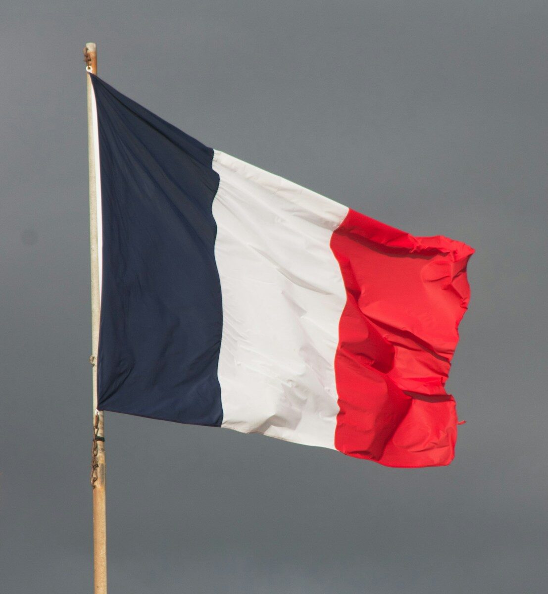 A flag flying in the wind on a cloudy day