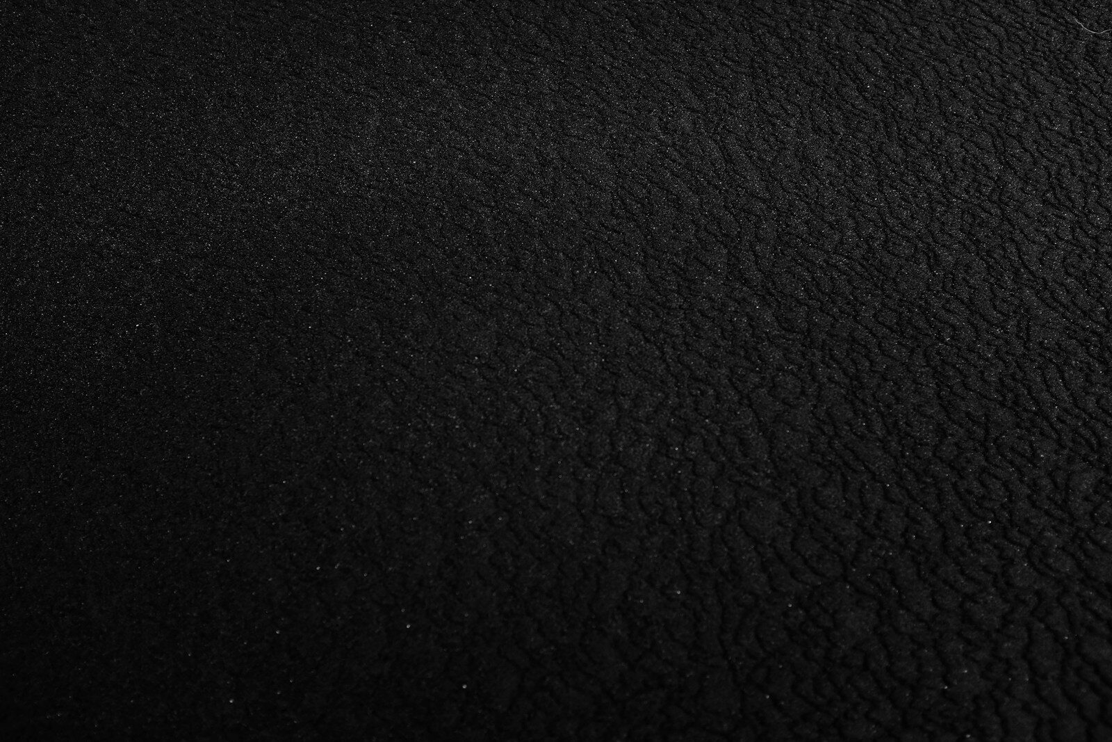 a black and white photo of a black surface